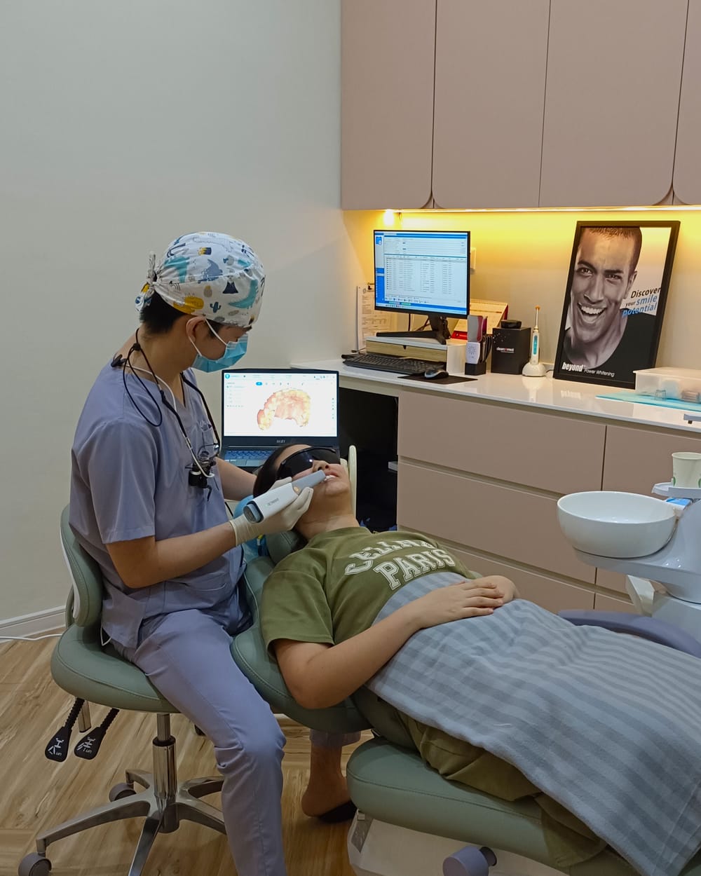 A dentist at Alpha Dental, Sutera Utama reviewing a digital scan with a patient