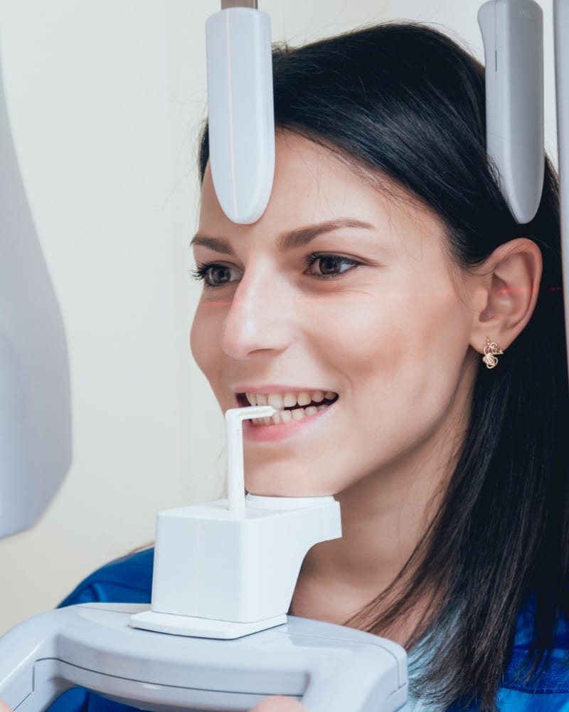 Dentist pointing out a finding on a digital dental X-ray displayed on a monitor at Alpha Dental, Sutera Utama